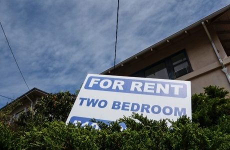 For Rent sign in front of apartment building