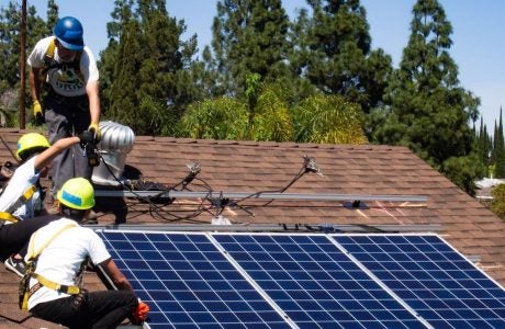 Roofers installing solar panels