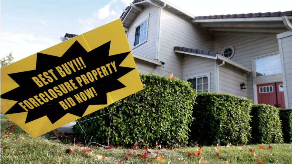 foreclosure sign in front of house