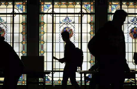silhouette of voters against stained-glass background