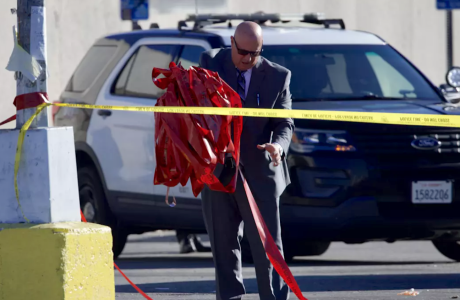 police detective at crime scene with police tape