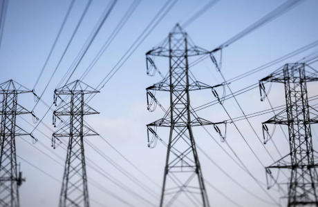 power lines silhouetted against blue sky