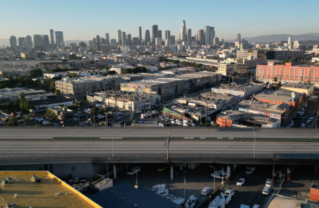 empty stretch of freeway with Los Angeles skyline in background