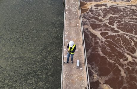 worker on platform at wastewater treatment plant