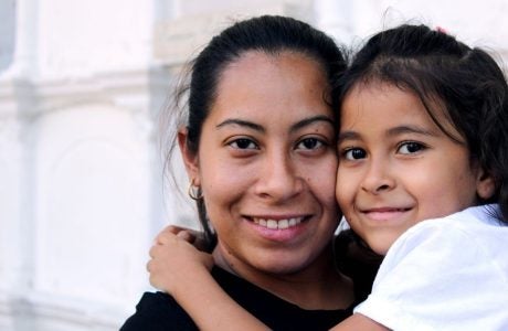 Woman holding little girl