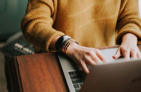 woman typing on laptop