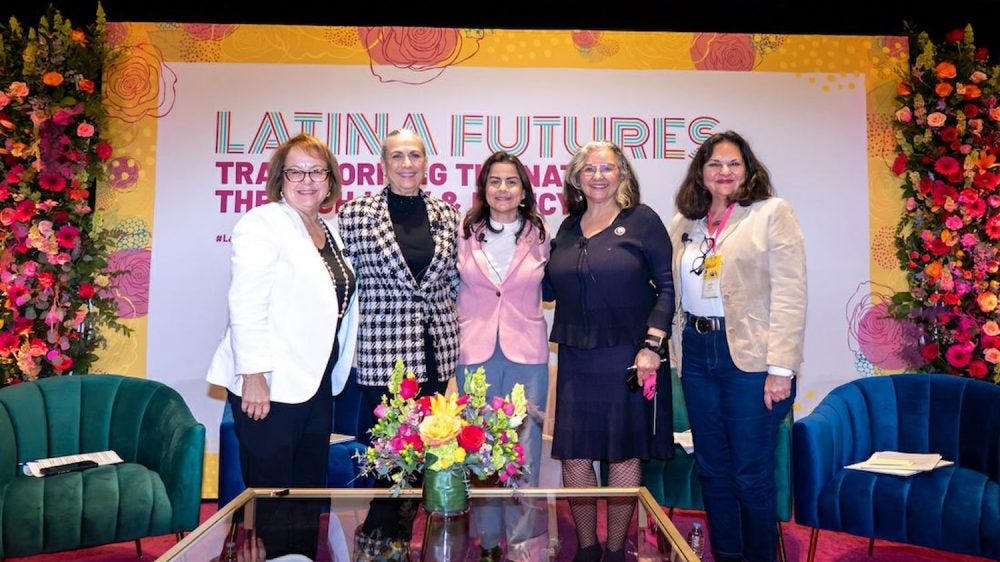 Five women standing in from of sign saying "Latina Futures"