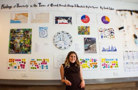 Young woman in front of art display