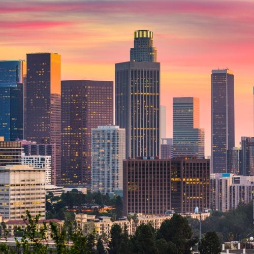 Los Angeles Downtown skyscrapers and cityscape against a sunset orange sky.