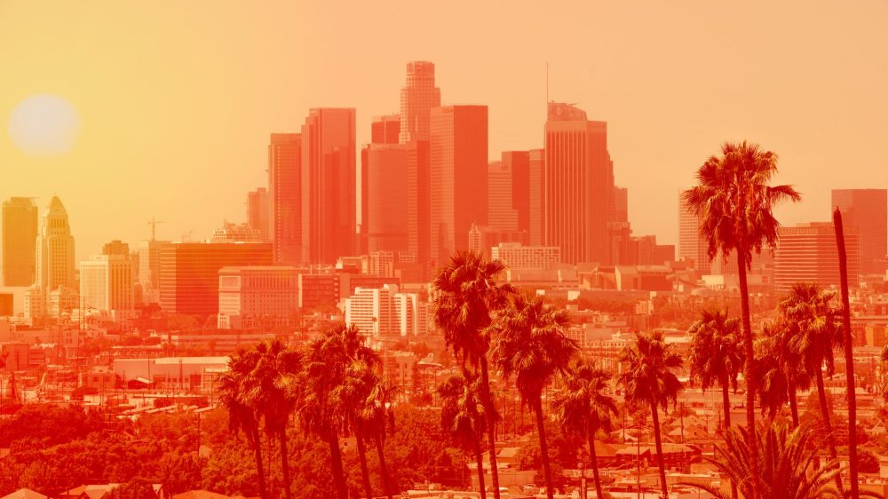 Photo of Los Angeles downtown with palm trees on an extremely hot day, the photo is in a bright orange filter to indicate heat levels|Image of air conditioner.