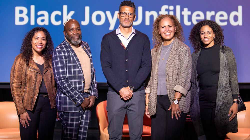 Panelists from the Luskin Lecture on February 25 at the UCLA Nimoy Theater with Michael Harriot, Michael Lens, and Safiya Noble stand on center stage to pose for a group photo.
