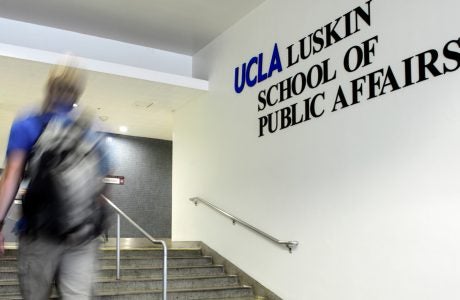 student ascending steps inside Luskin School
