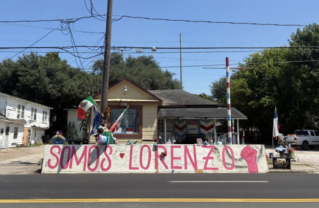 memorial in front of house with sign saying "Somos Lorenzo"
