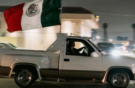 Image of truck flying Mexican flag.