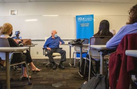 Man in chair speaking to classroom