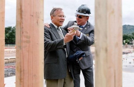 image of Mayor of Danville and handing the Town Manager a hammer at the ceremony of the construction site of new housing development