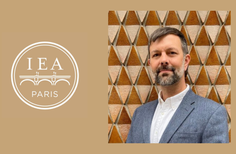 Photo of man in gray jacket next to logo reading "IEA Paris"