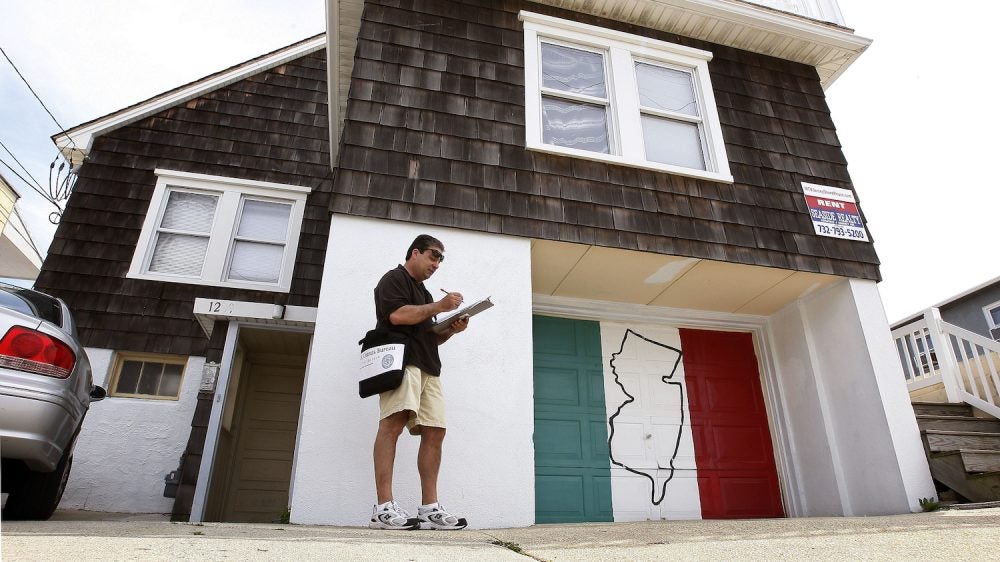 Census worker in front of house