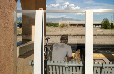 man waiting for train in heat