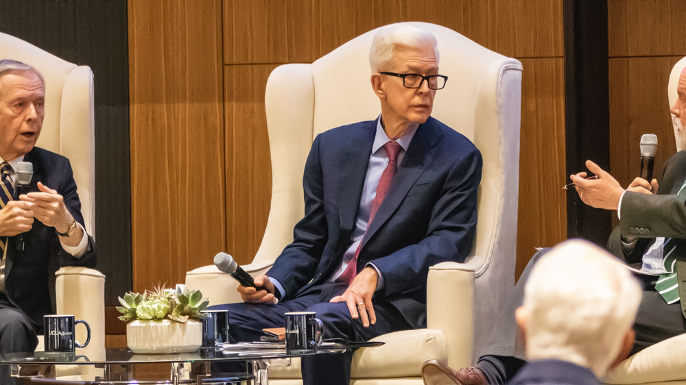 From left in large chairs on a stage during discussion at UCLA are Pete Wilson, Gray Davis and Jim Newton