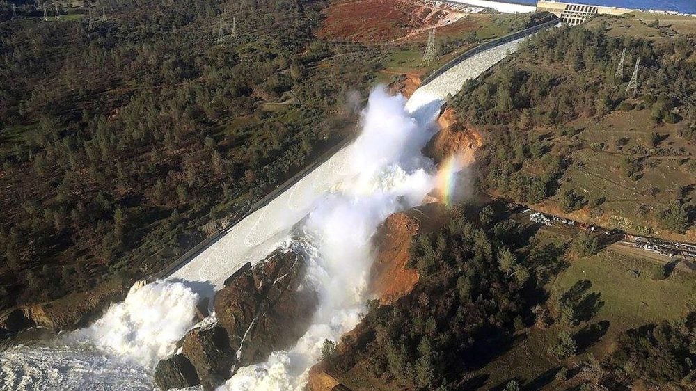 aerial view of water overflow on damaged dam