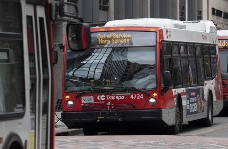 red and white bus with "Out of Service" sign