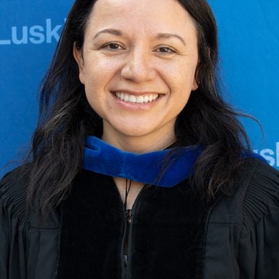 |woman in commencement cap and gown|woman in commencement cap and gown