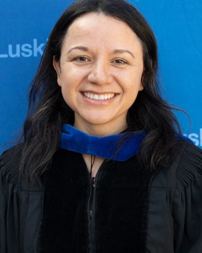 |woman in commencement cap and gown|woman in commencement cap and gown