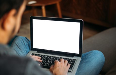 Man Using Laptop Blank Screen at Home
