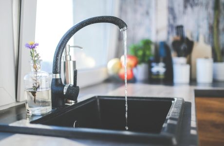 Kitchen faucet running water.