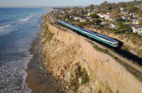 train along oceanside cliff