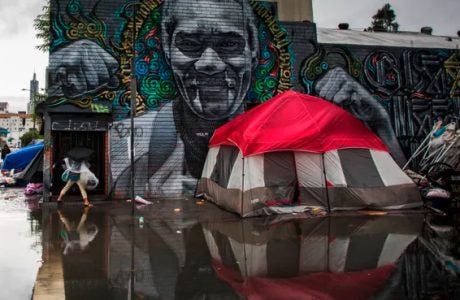 |a tent in an underpass where homeless people are sometimes found|Photo of homeless tent on sidewalk|