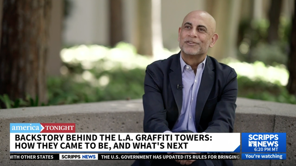 Man sitting outside as part of news footage