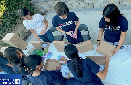 youth filling small cardboard boxes with written material