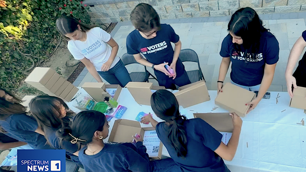 youth filling small cardboard boxes with written material