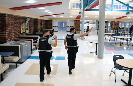 two school police officers in campus cafeteria
