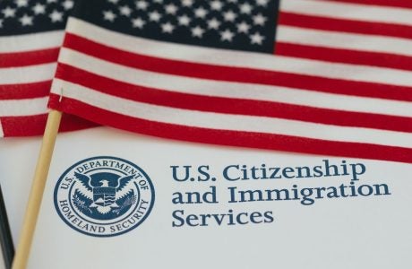 U.S. flag and citizenship and immigration paperwork