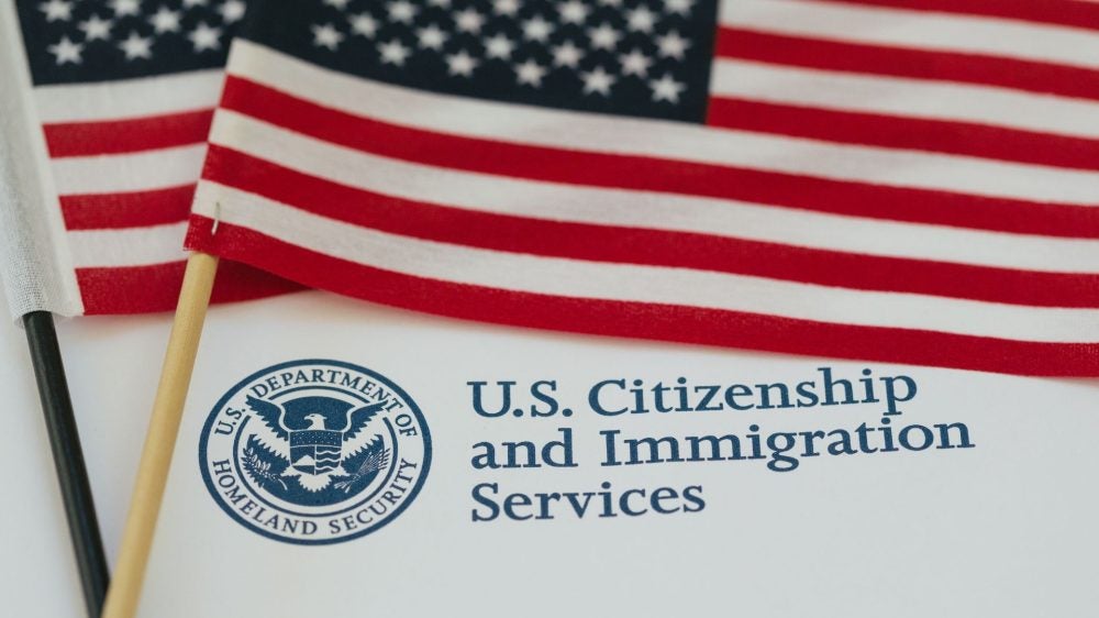 U.S. flag and citizenship and immigration paperwork