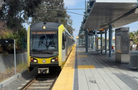 A yellow metro train at a station.