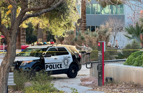 police car and officers in front of building