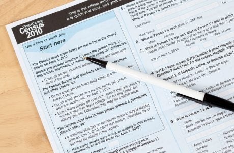 US, Census form document with pen on top|Family walking together.