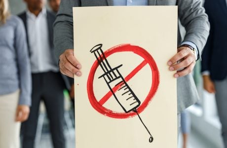 Protester holds anti-vaccine poster