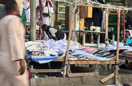 Merchants and vendors at Port Sundan, Sudan, with a man walk across the street