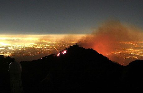 flames and smoke above lights of Los Angeles