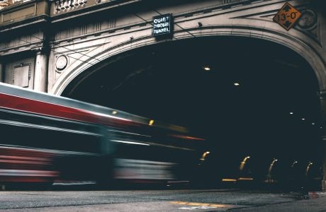 timelapse photo of bus entering tunnel