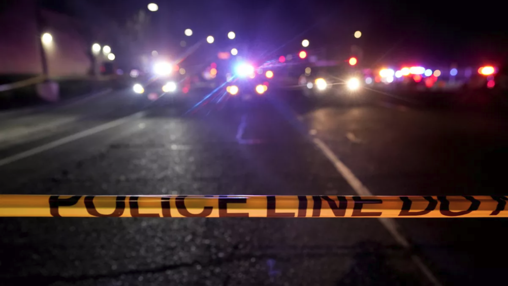 police tape in front of crime scene at night
