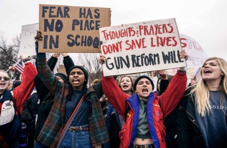 students holding signs promoting gun reform