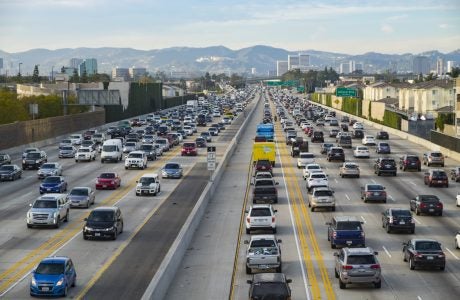 A northbound view of the 405 freeway during Friday afternoon traffic with Getty Museum, Westwood and Santa Monica mountains in the background.