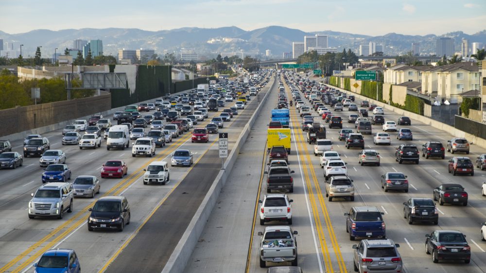 A northbound view of the 405 freeway during Friday afternoon traffic with Getty Museum, Westwood and Santa Monica mountains in the background.