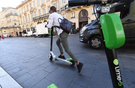 image of person riding a Lime scooter